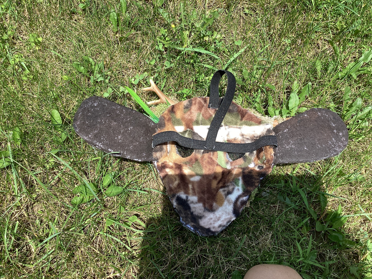 Axis deer therian mask with moss on it