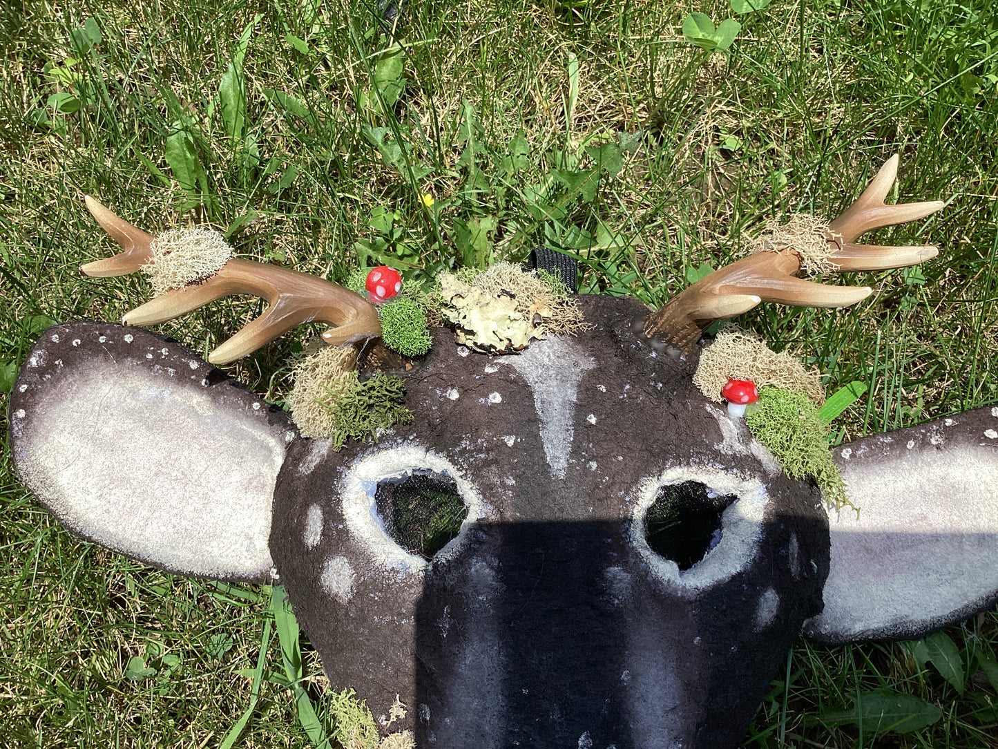 Axis deer therian mask with moss on it